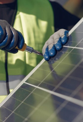 Engineer in a white helmet. Man near solar panel.